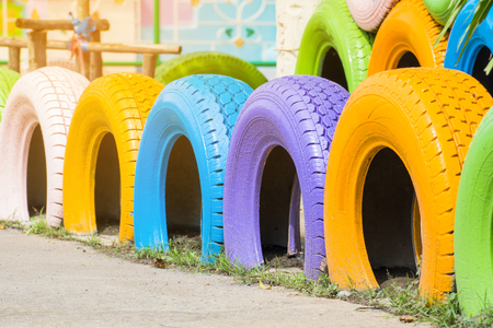 Colorful of old tire made building fence decoration in the garden at old schoolの写真素材