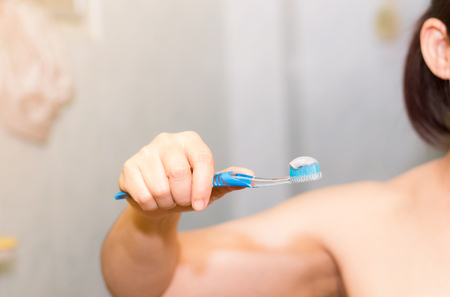 Close-up of asian woman show brush in hand for brushing her teeth,Dental health careの写真素材