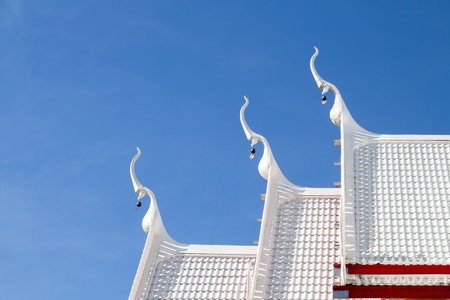 Beautiful white pavilion buddhist Thai temple roof. Thai white roof Church at Thai temple on sky backgroundの写真素材