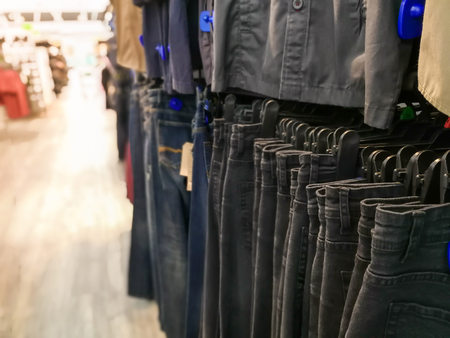 Asian woman shopping in supermarket store and buy Jeans,blur backgroundの写真素材