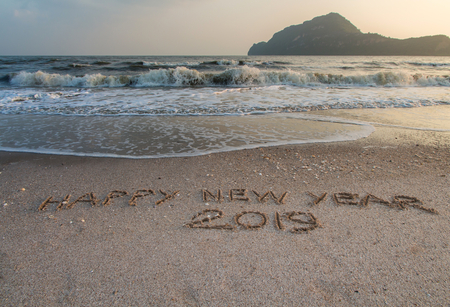 Happy New Year 2019,written in sand write on tropical beach with waveの写真素材