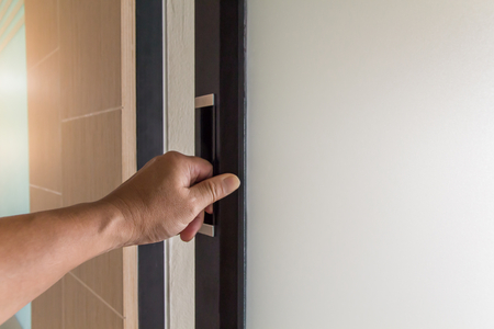 The hand of people open the door to inside ,outside door open putting into front doorの写真素材