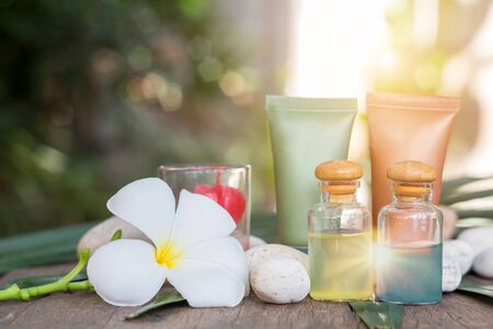 Aromatherapy product spa of therapy massage with plumeria or frangipani flowers, stones, aroma candle and oil on the desk,Spa treatment and skincare concept.の写真素材