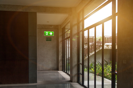 Green emergency exit sign and label no smoke in rest corner showing the way to escape and caution safety awarenessのeditorial素材