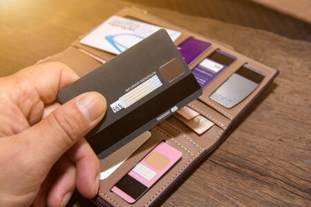 Many credit cards or debit cards on wooden floor