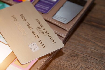 Many credit cards or debit cards on wooden