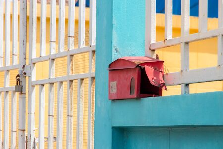 Mailbox in front of the house and gate with sunlight and beautiful natural background,The letter box looks old and damage
の写真素材