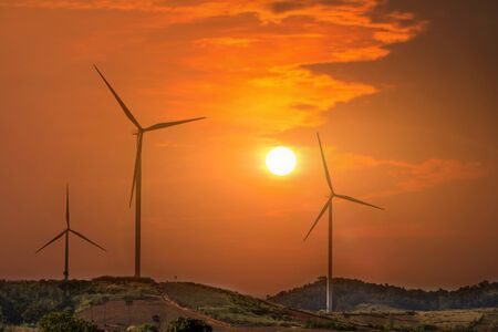 Wind turbines farm on mountanis landscape against sunset with clouds background,Windmills for...