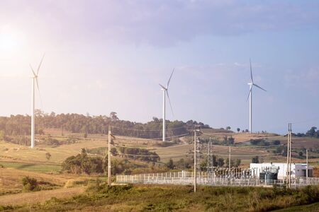 Wind turbines farm on mountanis landscape against blue sky with clouds background,Windmills for...