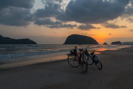 silhouette of bicycle at beach, bicycles on beach sunset or sunriseの写真素材