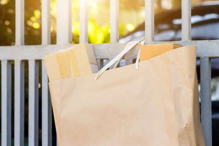 The goods package and sent to receiver at home,Delivery man holding boxes person who sent the package box to the recipient to arrive at homeの写真素材