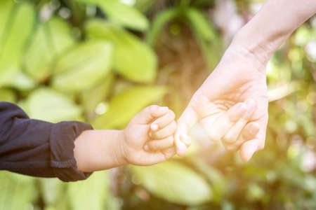 Couple holding hands of child and adult,To hold hands together people conceptの写真素材