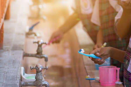 Old faucet in row,old valve faucet with dirty blass faucet in old tub on school children