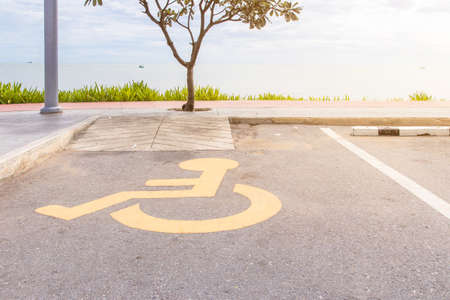 Handicapped parking spot with disability symbol on the asphalt reserved for handicapped people, parking on the beachの写真素材
