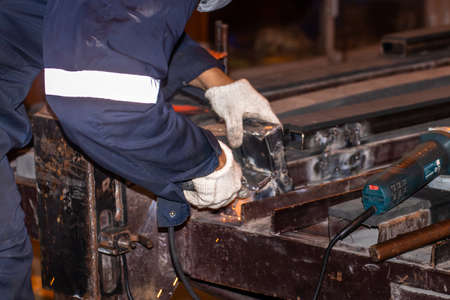 Man working welding steel,male worker metal is part in factory with PPE safety