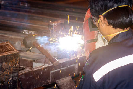 Man working welding steel,male worker metal is part in factory with PPE safety