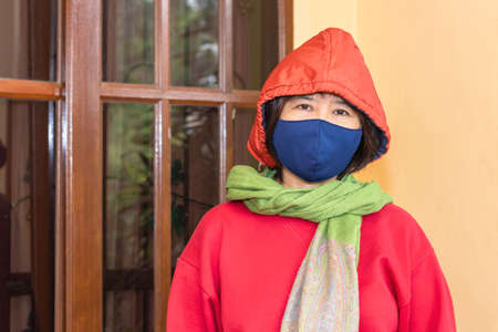 Asian women wear surgical mask or face mask before leaving home reduce the infection from covid-19