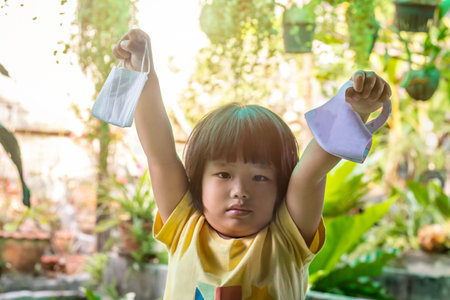 Asian kid with the mask for protect them self from virus and reduce spread of the coronavirus...