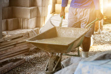 Workers pour concrete in the construction site,Steel bars used for floor construction working ,Workers pour for the construction of a residential buildingの写真素材