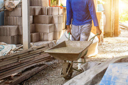Workers pour concrete in the construction site,Steel bars used for floor construction working ,Workers pour for the construction of a residential buildingの写真素材