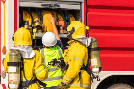 Firefighter training,Firefighters prepare equipment from fire trucks for fire hose drills in the factory.の写真素材