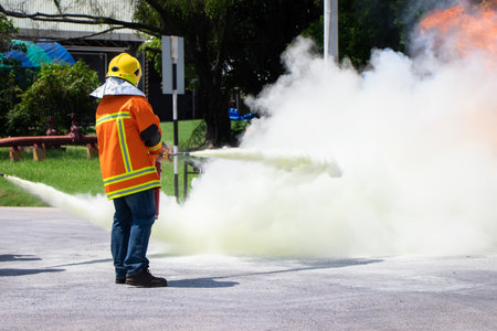 Firefighter training,Instructor Training on the use of fire hoses extinguisher for fighting fire in the factoryの写真素材
