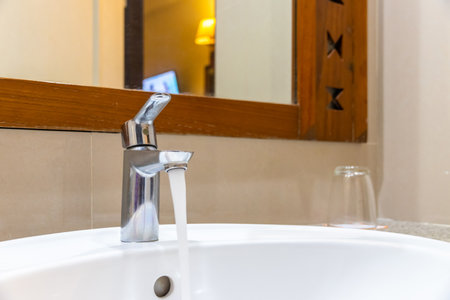 Shower head in modern bathroom with water drops flowing.Sanitary ware for bathroom interior.Running water of shower faucet,close-up tap or faucet in bathroom splashing.の写真素材