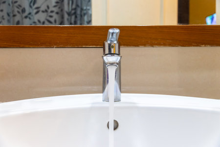 Shower head in modern bathroom with water drops flowing.Sanitary ware for bathroom interior.Running water of shower faucet,close-up tap or faucet in bathroom splashing.の写真素材