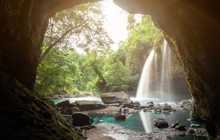 Small waterfall with water splashing and tumbling over the rocks in the forest on a bright sunny,Haew Suwat Waterfallの写真素材