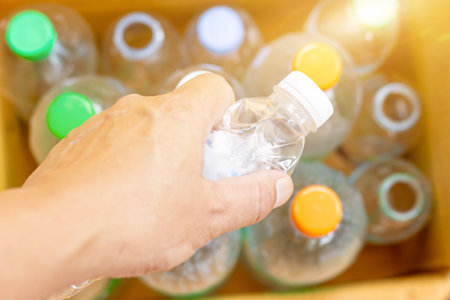 Hand hold old plastic bottles and containers set for recycling,Rubbish, rubbish, garbage, plastic waste, plastic waste pollutionの写真素材