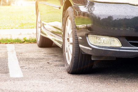 A front view of a car scene behind a parking lot in a tourist destination.