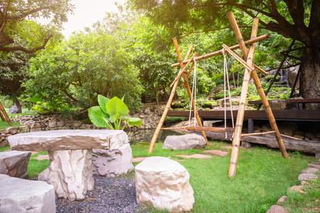 Wooden swing made from bamboo for decoration in a beautiful garden or resort.の写真素材