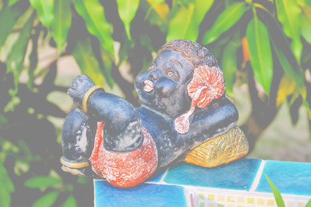 The A stucco Negrito was placed beside the tree.の写真素材