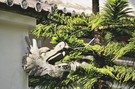 Stucco dragon heads were hung on the walls.の写真素材