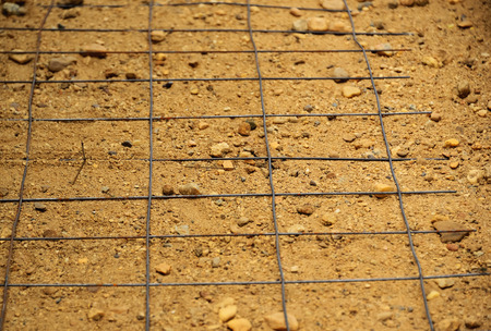 Steel mesh is placed in the sand to the prepared cement.の写真素材