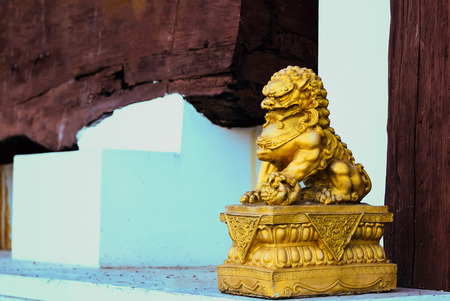Lion statues were placed on wooden posts.の写真素材