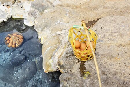 Cooked eggs are removed from the hot springs.の写真素材