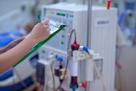 The specialist are checking continuous renal replacement therapy equipment and injection pump and hemodialysis machine.の写真素材