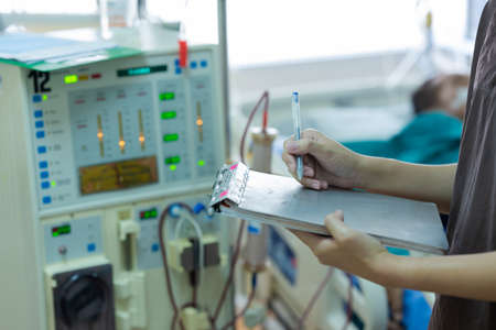 The specialist are checking continuous renal replacement therapy equipment and injection pump and hemodialysis machine.の写真素材