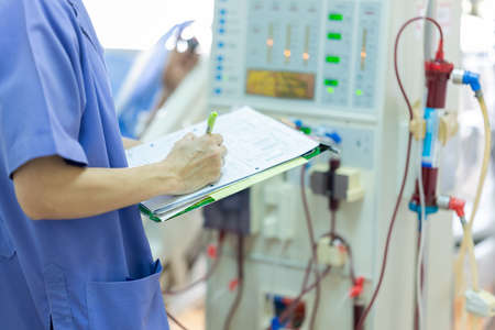 The specialist are checking continuous renal replacement therapy equipment and injection pump and hemodialysis machine.の写真素材