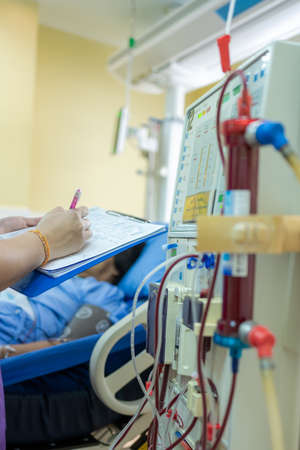 The specialist are checking continuous renal replacement therapy equipment and injection pump and hemodialysis machine.の写真素材