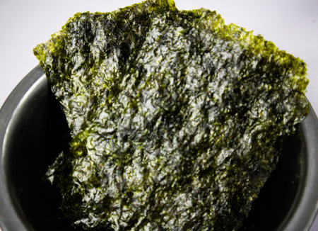 Crispy nori seaweed on bowl with white background. Japanese dry seaweed sheets.の写真素材
