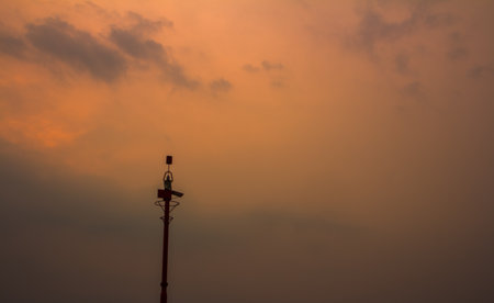 Silhouette of high pole on beautiful twilight sky