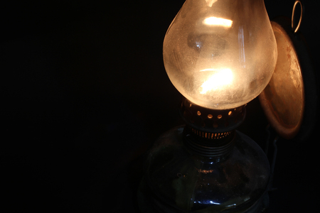 Old lamp illuminates darkness of the night.の写真素材