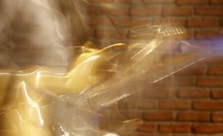 Playing electric guitar on stage. Blurred image.