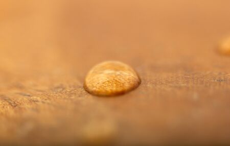 One water drop on a wooden surface. Textured, Backgrounds.の写真素材