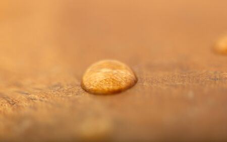 One water drop on a wooden surface. Textured, Backgrounds.の写真素材