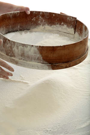 chef sifting flour for bread makingの写真素材