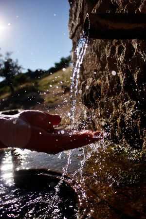 Fresh mountain waters. Drinking clean spring water.