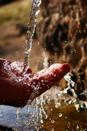 Fresh mountain waters. Drinking clean spring water.の写真素材